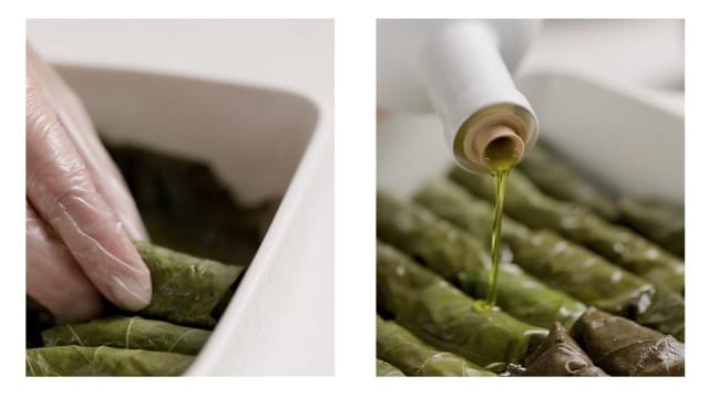Placing the stuffed grape leaves side by side in the stove-top dish.  A photo showing PJ Kabos Extra Virgin Olive Oil being drizzled over the top.