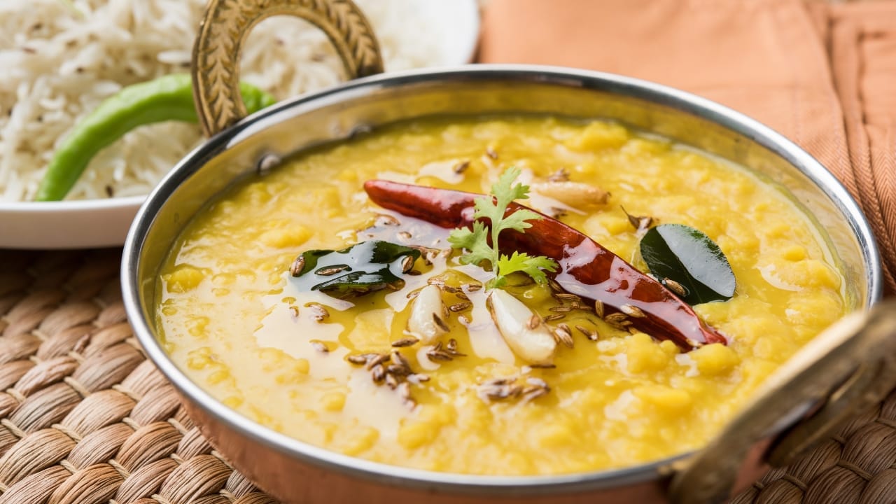 A bowl of Toor Dal with jeera (cumin) rice on the side. 