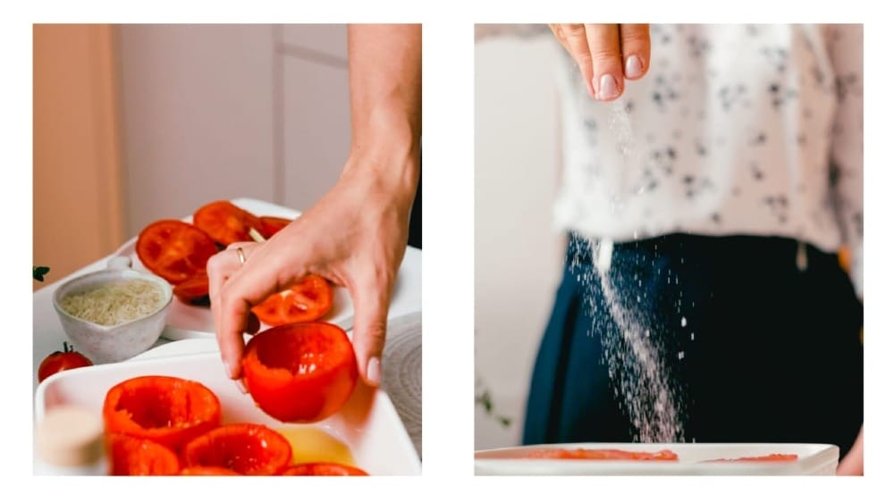 Scooped out tomatoes being placed in the baking pan and salted.