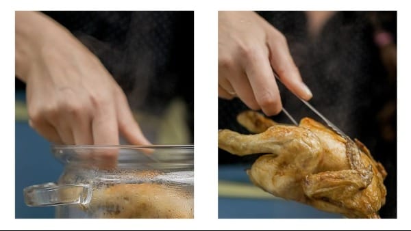 Boiled chicken being removed from a pot.