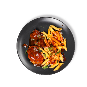 Plated chicken dinner in an olive-oil infused tomato sauce served with pasta.